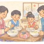 Korean family wearing hanbok and eating tteokguk together at home during Seollal, Korean Lunar New Year.