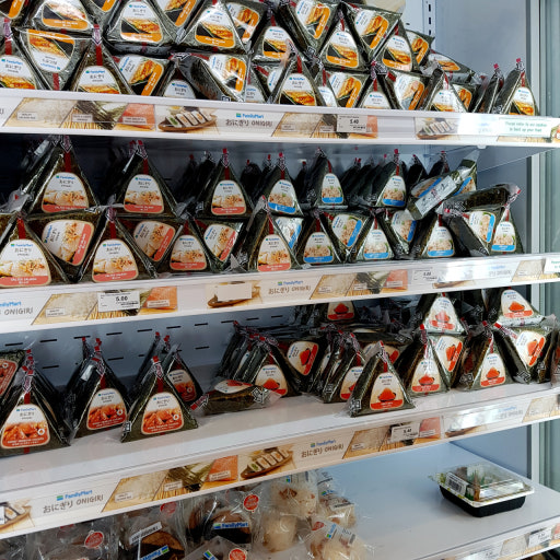 Korean triangle kimbap samgak gimbap in convenience store with various fillings on